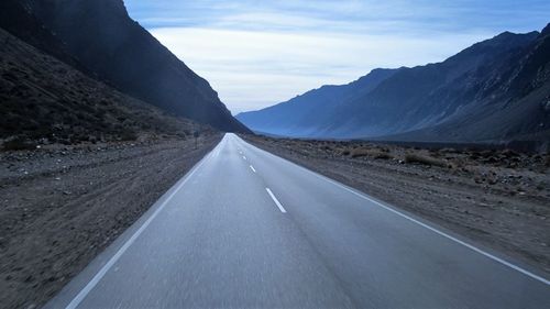 Empty road leading towards mountains