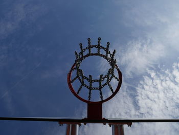 Low angle view of silhouette against blue sky and clouds