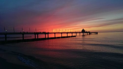 Silhouette of pier at sunset