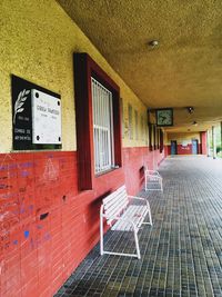 Empty chairs against wall in building