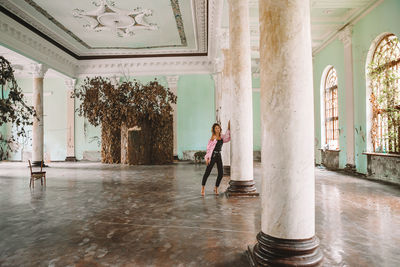 Woman standing by building