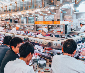 Rear view of people working at restaurant