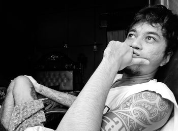 Portrait of young man sitting at home