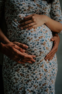 Midsection of woman with arms raised