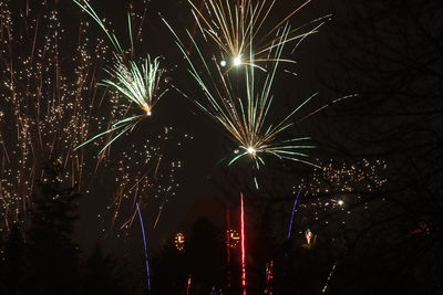 Low angle view of firework display at night