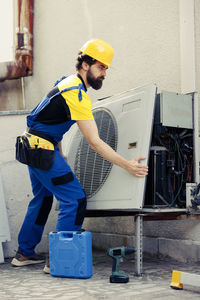 Rear view of man working at construction site