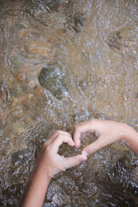 Close-up of woman hand in water