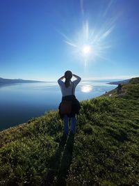 Rear view of a woman standing in the vineyards of lavaux, on the shores of lake leman 