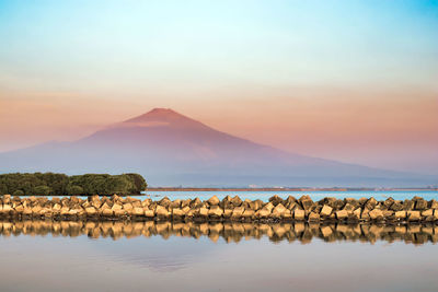 Scenic view of lake against sky during sunset