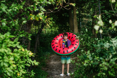 Teen boy with watermelon float ready for the beach