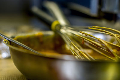 Close-up of wire whisk on bowl