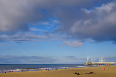 View of beach against cloudy sky