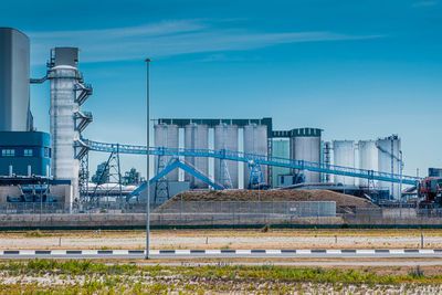 Factory with transport system against sky