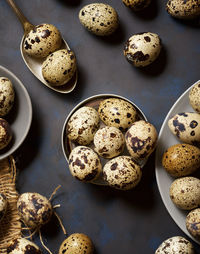 Quail eggs on a black table.