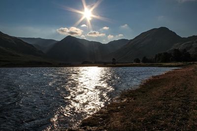 Scenic view of lake and mountains against sky