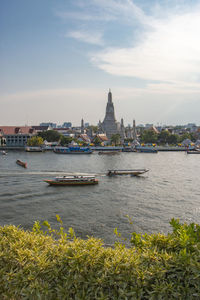 Boats in river with church in background