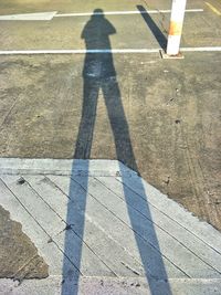 Shadow of person on road