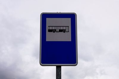 Low angle view of road sign against sky