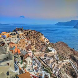 High angle view of townscape by sea against sky