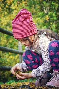 Girl looking away while standing outdoors