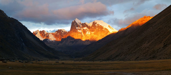 Panorama of spectacular sunset in the snowy mountains and valleyremote cordillera huayhuash in peru.