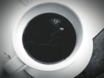 Close-up of black coffee in window