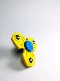 Close-up of yellow toy over white background