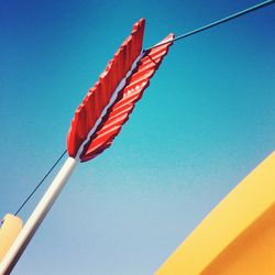 Low angle view of flag against clear blue sky