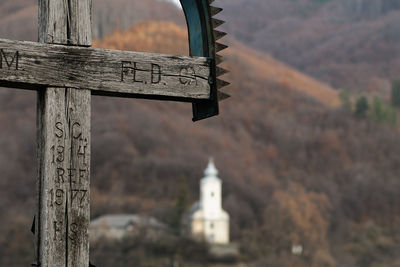 Close-up of text on wood against building