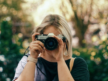 Portrait of woman photographing