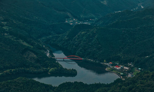 High angle view of river amidst mountains against sky