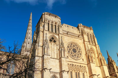 Low angle view of historical building against blue sky