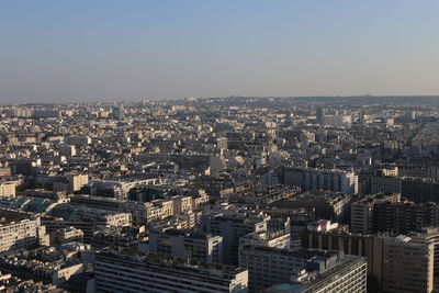 High angle view of illuminated city buildings against clear sky