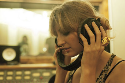 Portrait of a young woman in a recording studio