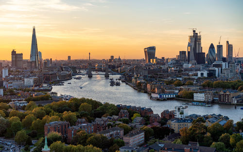 Buildings in city at sunset