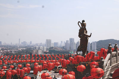 Statue with city in background