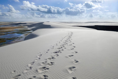 Scenic view of sand dunes against sky