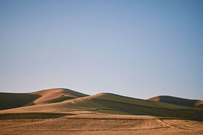 Scenic view of arid landscape against clear sky