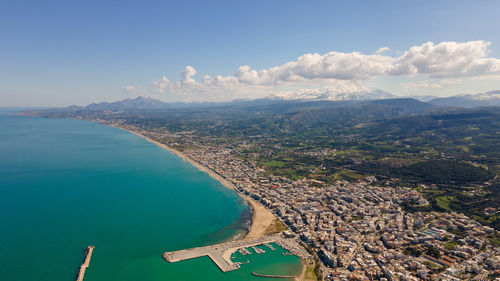 Aerial view of sea and mountains against sky