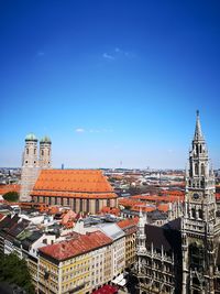 High angle view of buildings against blue sky