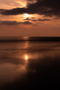 Scenic view of sea against orange sky