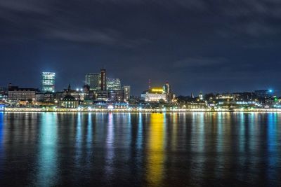 Illuminated city at waterfront