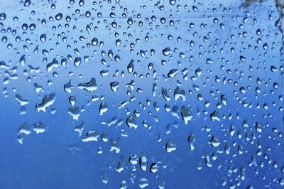 Full frame shot of wet glass window during rainy season