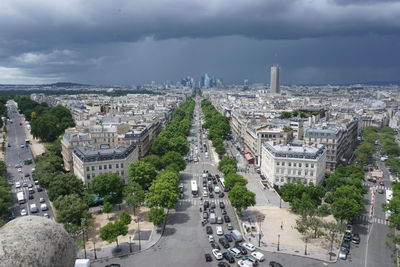 High angle view of city street against cloudy sky