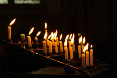 Close-up of illuminated candles at church