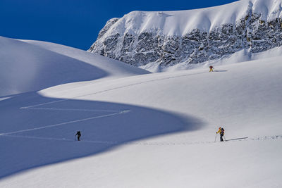 People skiing on snowcapped mountain