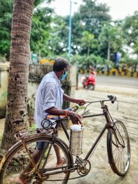 Man riding bicycle on tree trunk