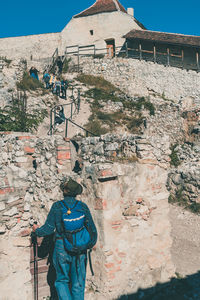 Rear view of man standing by building