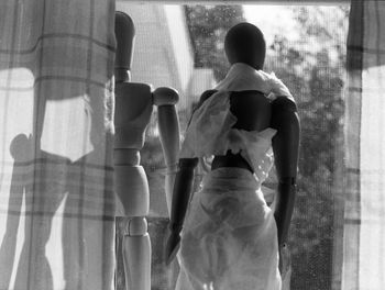 Rear view of men on window