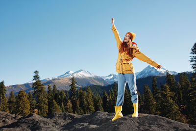 Rear view of woman standing on mountain